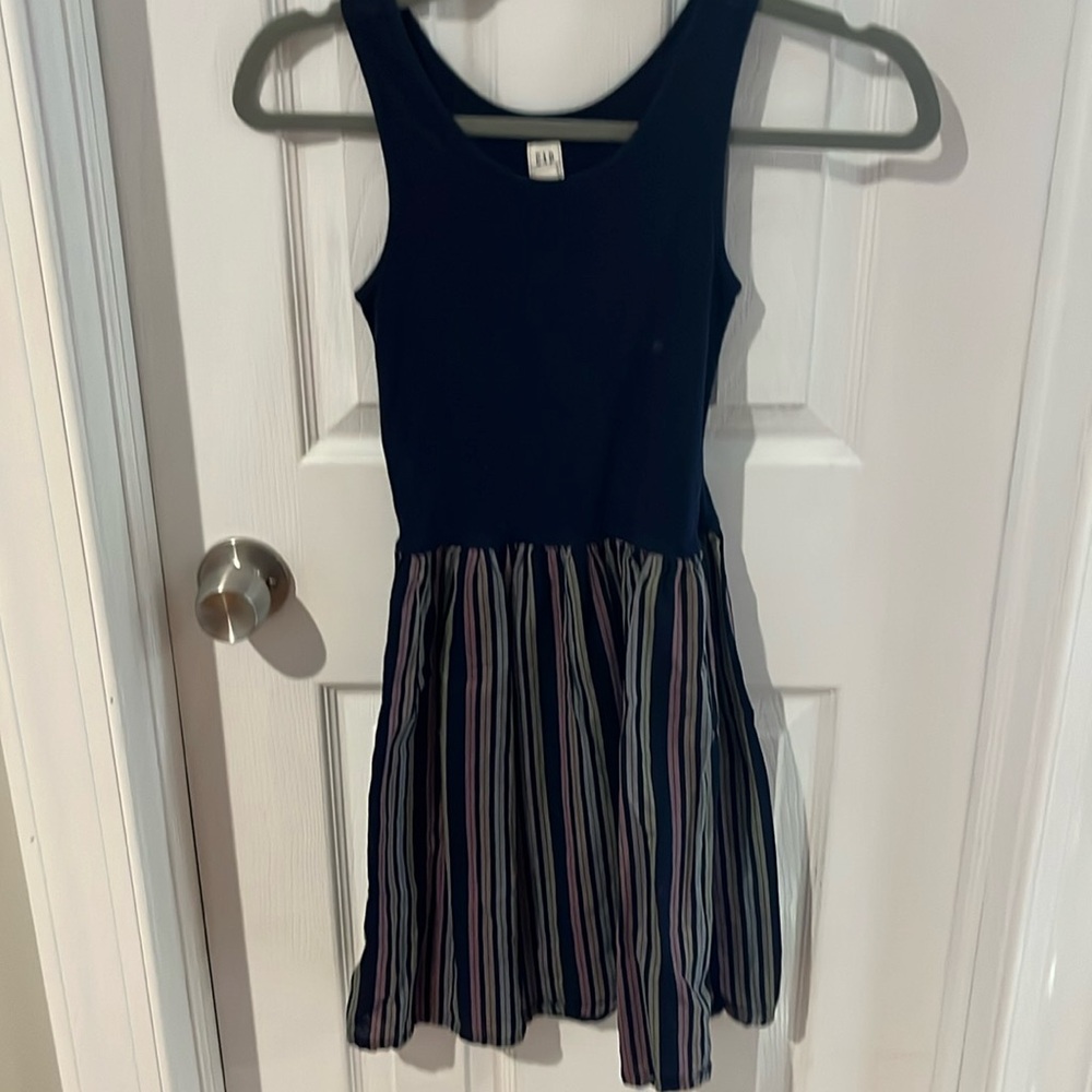 Dress with navy blue top sleeveless and with multi color stripes at skirt part